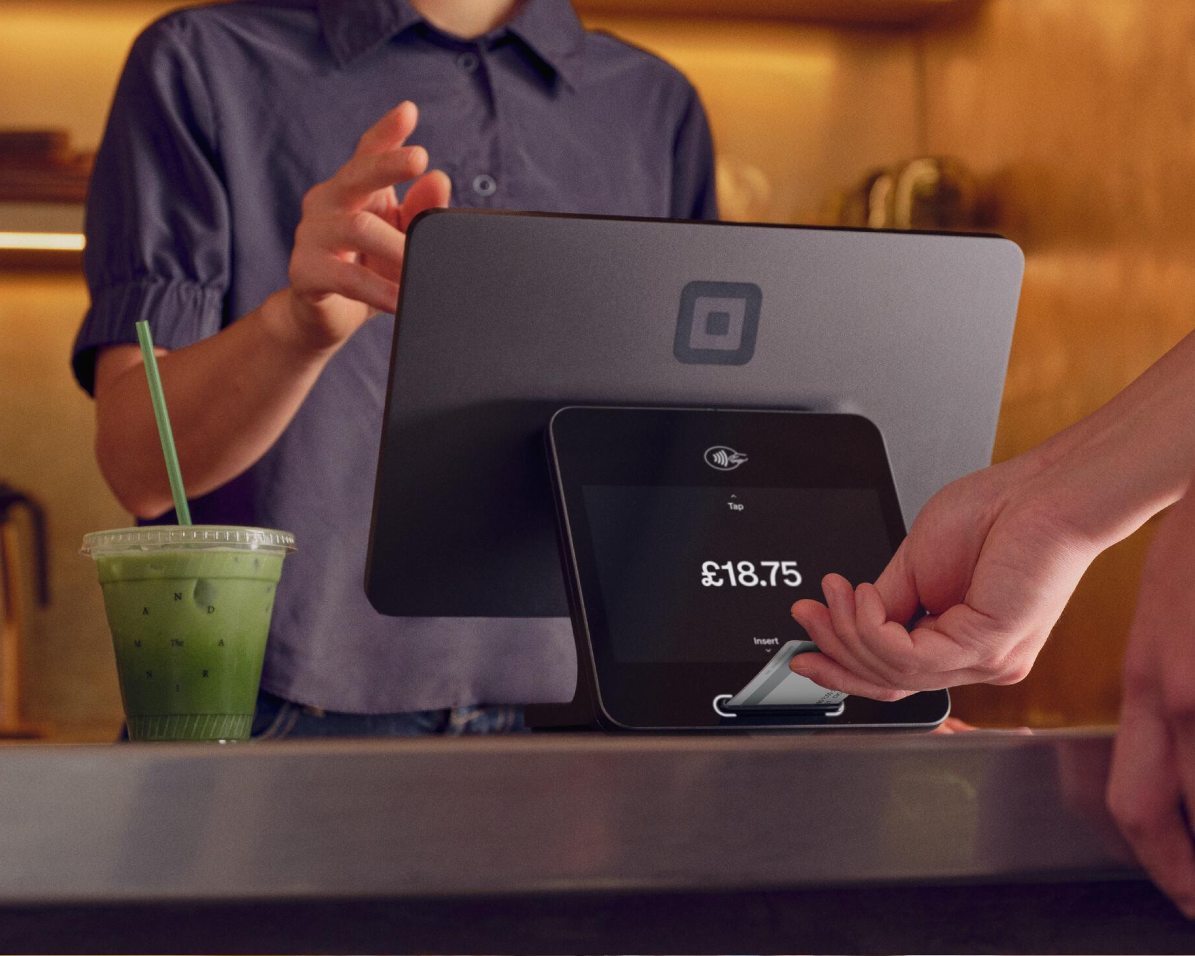 Customer making a contactless payment at a counter